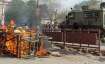 A cart set ablaze in violent clashes between two groups