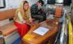 Family members mourn near a casket containing remains of