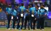 Sri Lankan players regroup after taking a wicket of the Netherlands in Sharjah on Friday.