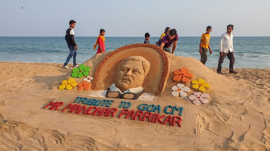 Sand artist Manas Sahoo makes a sand art to pay homage to Goa's Chief Minister Manohar Parrikar, who passed away battling pancreatic ailment, in Puri.