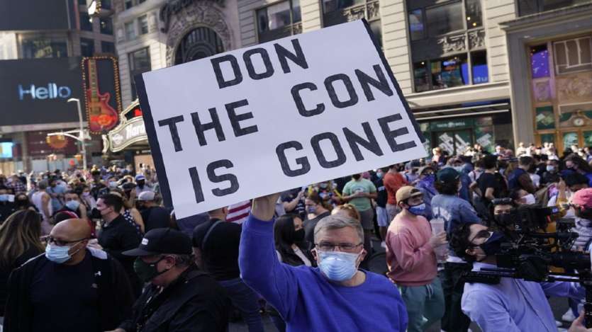 People celebrate in Times Square after former vice president and Democratic presidential candidate Joe Biden was announced as the winner over Pres. Donald Trump to become the 46th president of the United States in New York.