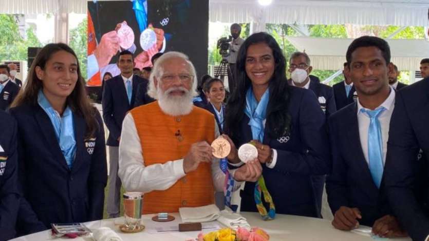 PM Modi with Sindhu and Indian swimmers.