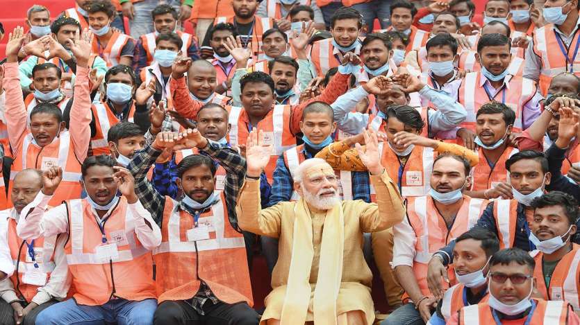 Prime Minister Narendra Modi with the workers of the Kashi Vishwanath Dham redevelopment project, during the inauguration of the Dham, in Varanasi.