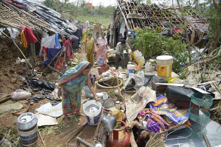 A woman sorts valuable items recovered from her damaged